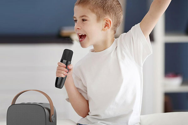 A child happily singing into a colorful kids karaoke microphone
